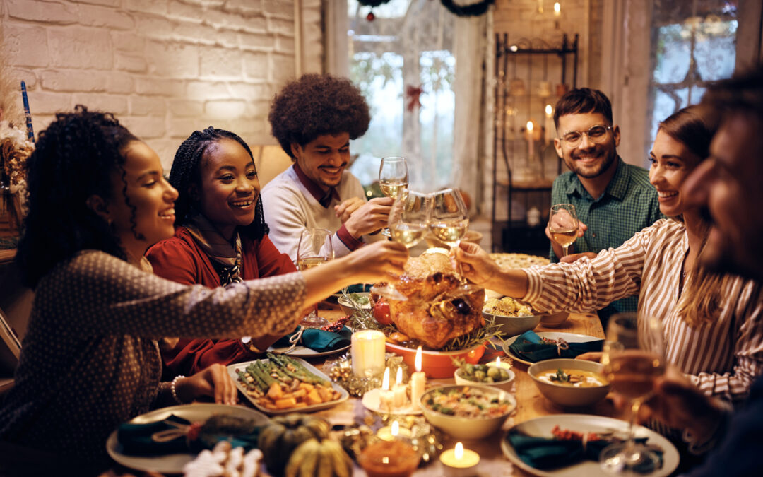 Celebrating Thanksgiving Eve - A group of friends sharing food and wine during a Thanksgiving party.